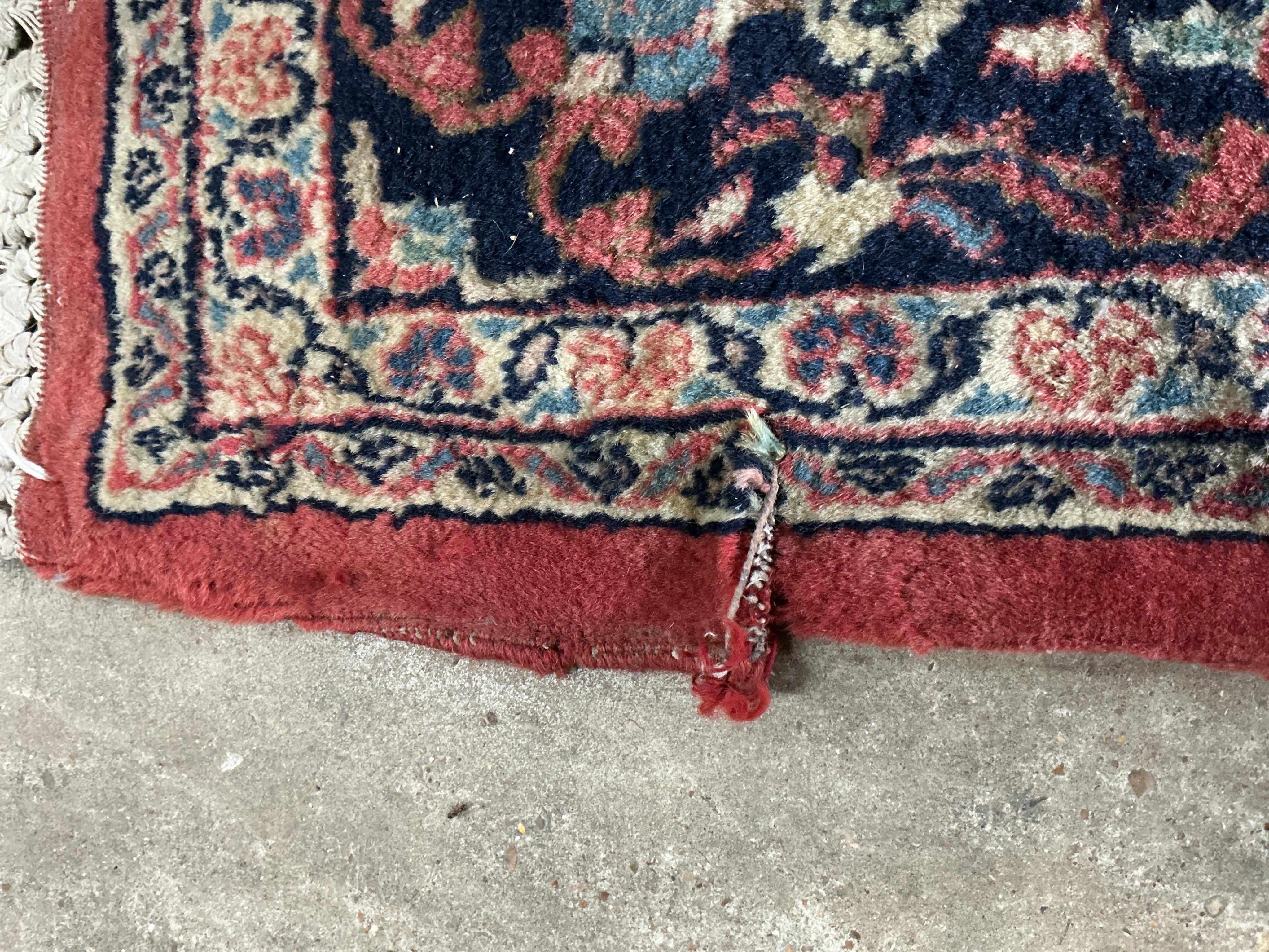 A Sarouk red ground rug, 251 x 154cm